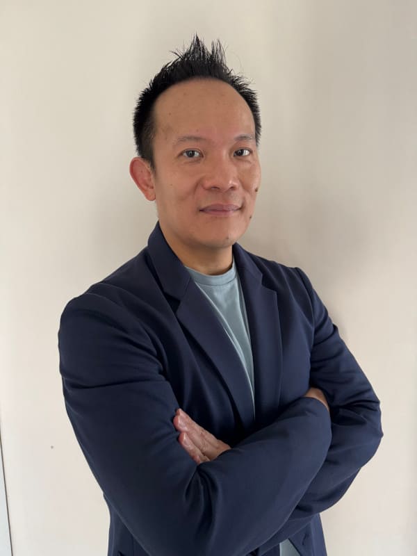 Charles Tang, CEO and Co-Founder of Youniverse Games, in a professional setting.